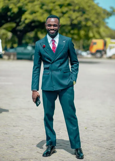 Portrait of Pastor Joseph Kwabla Tetteh in a green suit